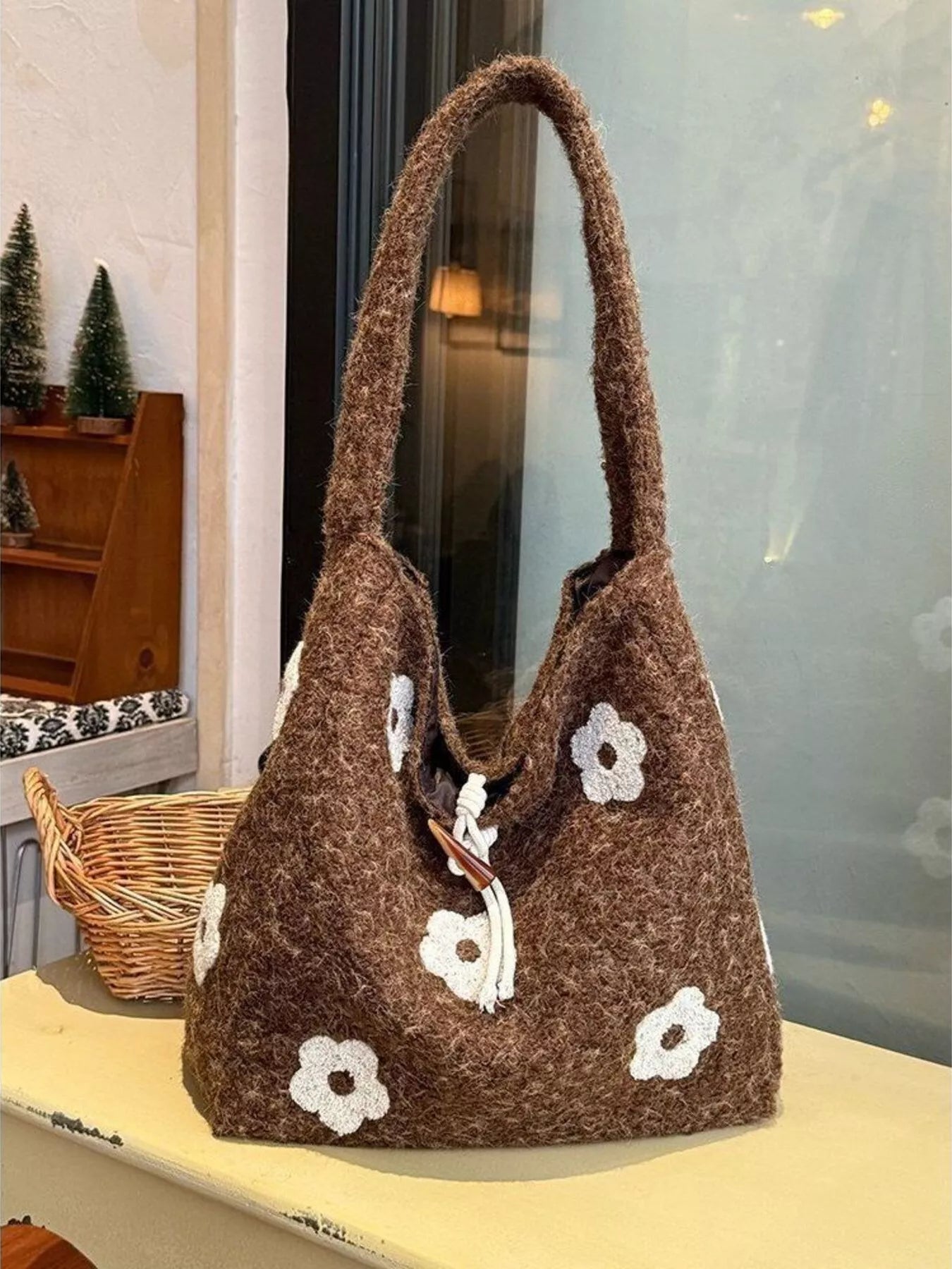 Plush drawstring tote bag with flower details and soft texture, large size.