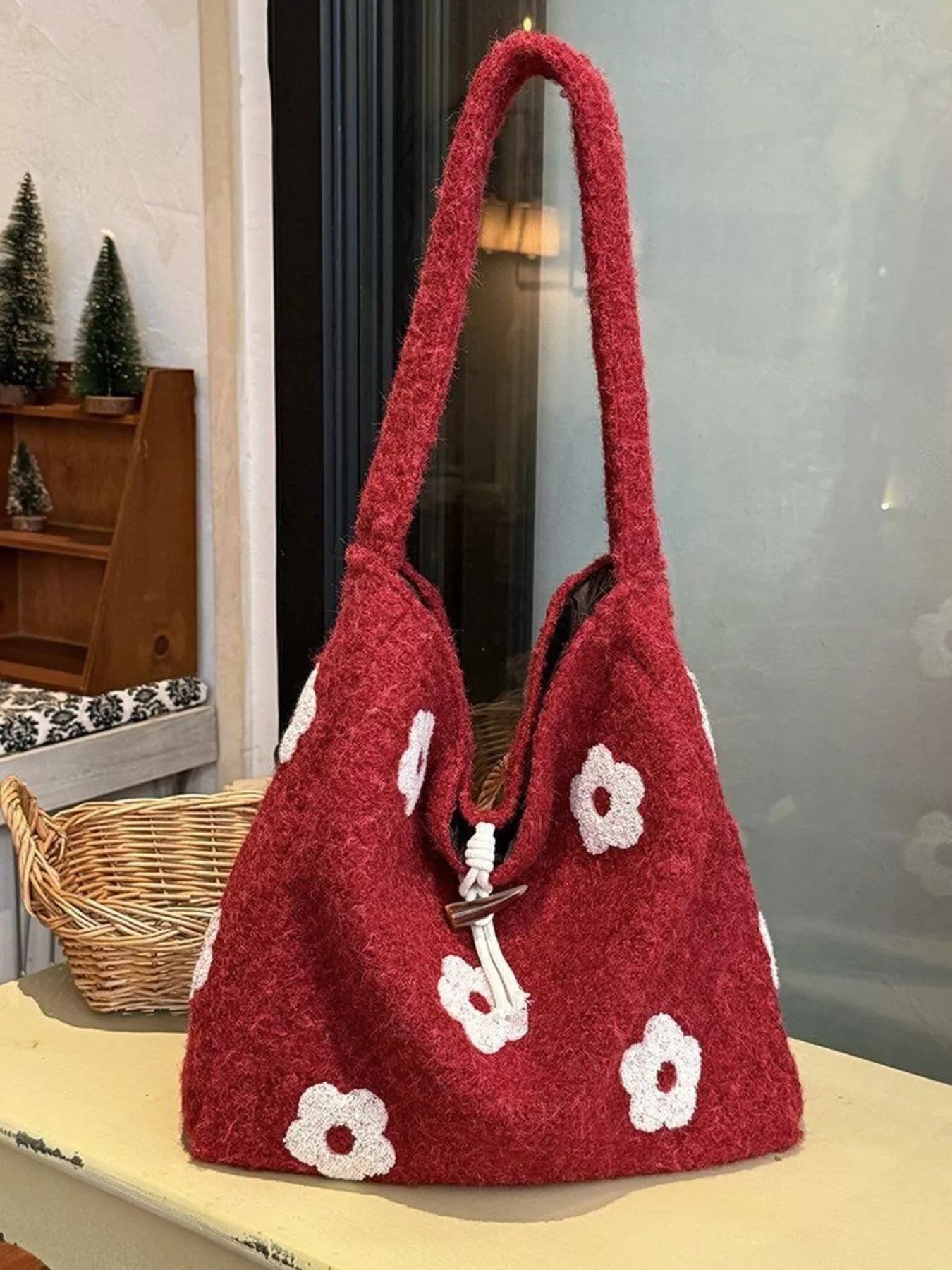 Plush drawstring tote bag with flower details and soft texture, large size.