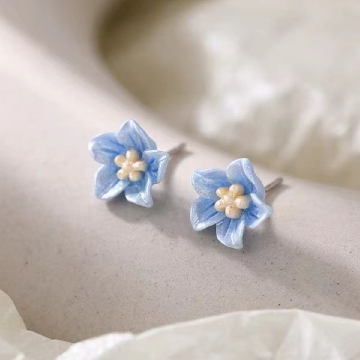 Small floral stud earrings with delicate resin petals