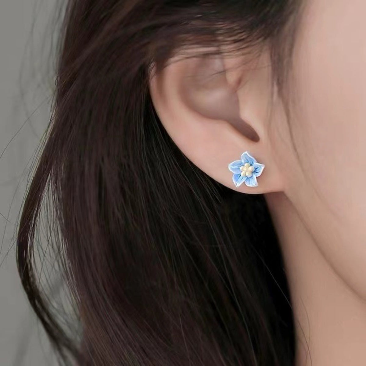 Small floral stud earrings with delicate resin petals