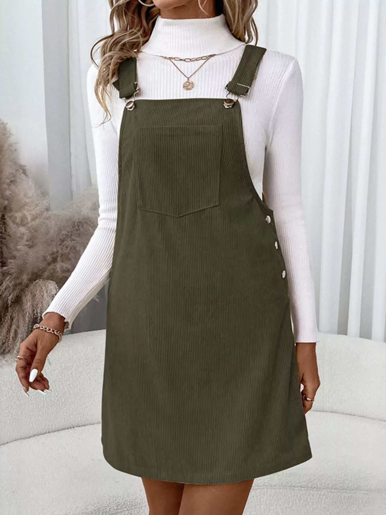 Olive green Pinafore Dreams corduroy overall dress with front pocket and button sides