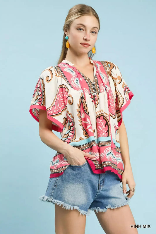Pink mix paisley flutter sleeve top with tassel tie detail styled with denim shorts.