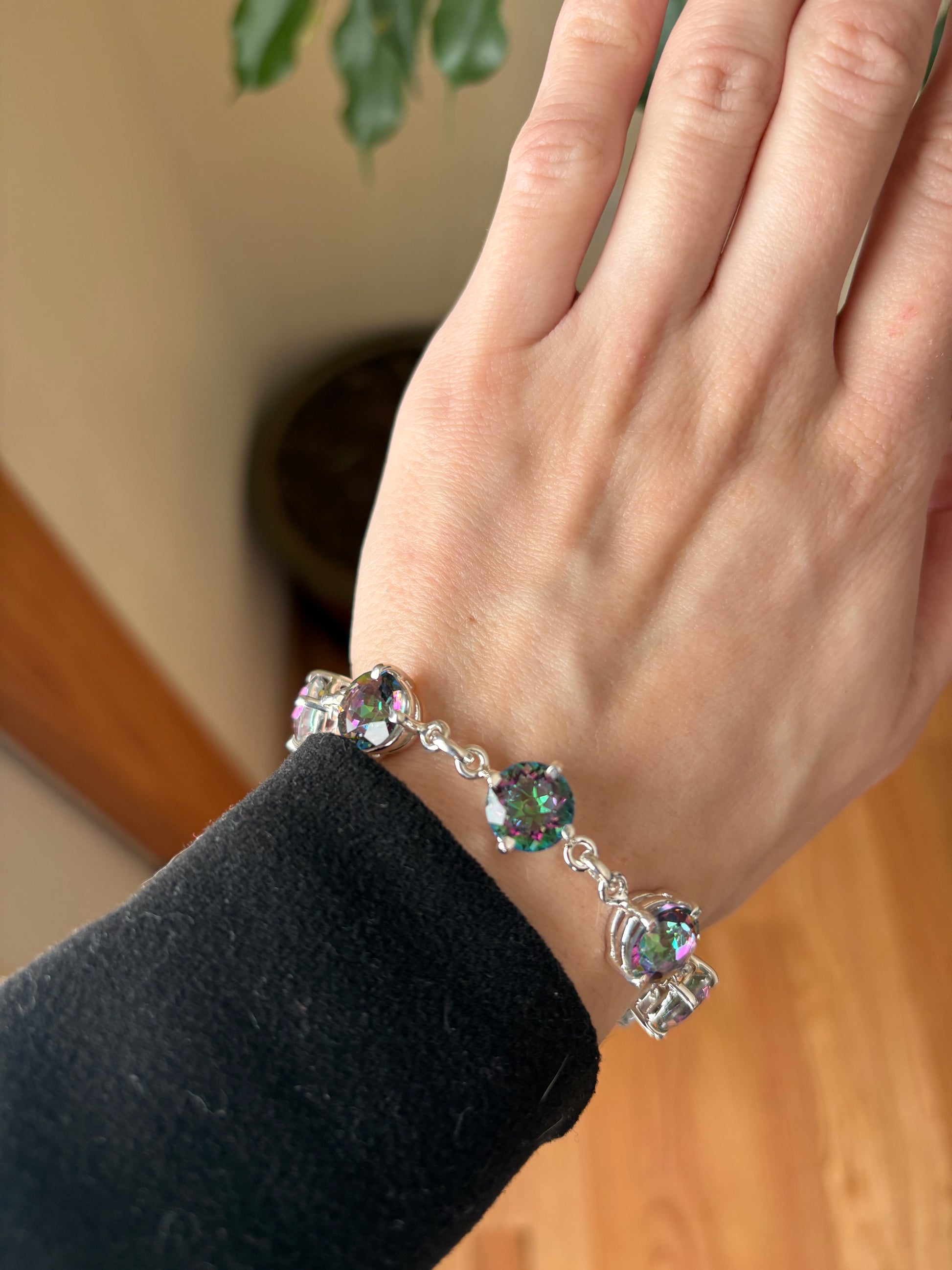 Sterling silver mystic quartz bracelet featuring iridescent round stones that shift colors in the light.