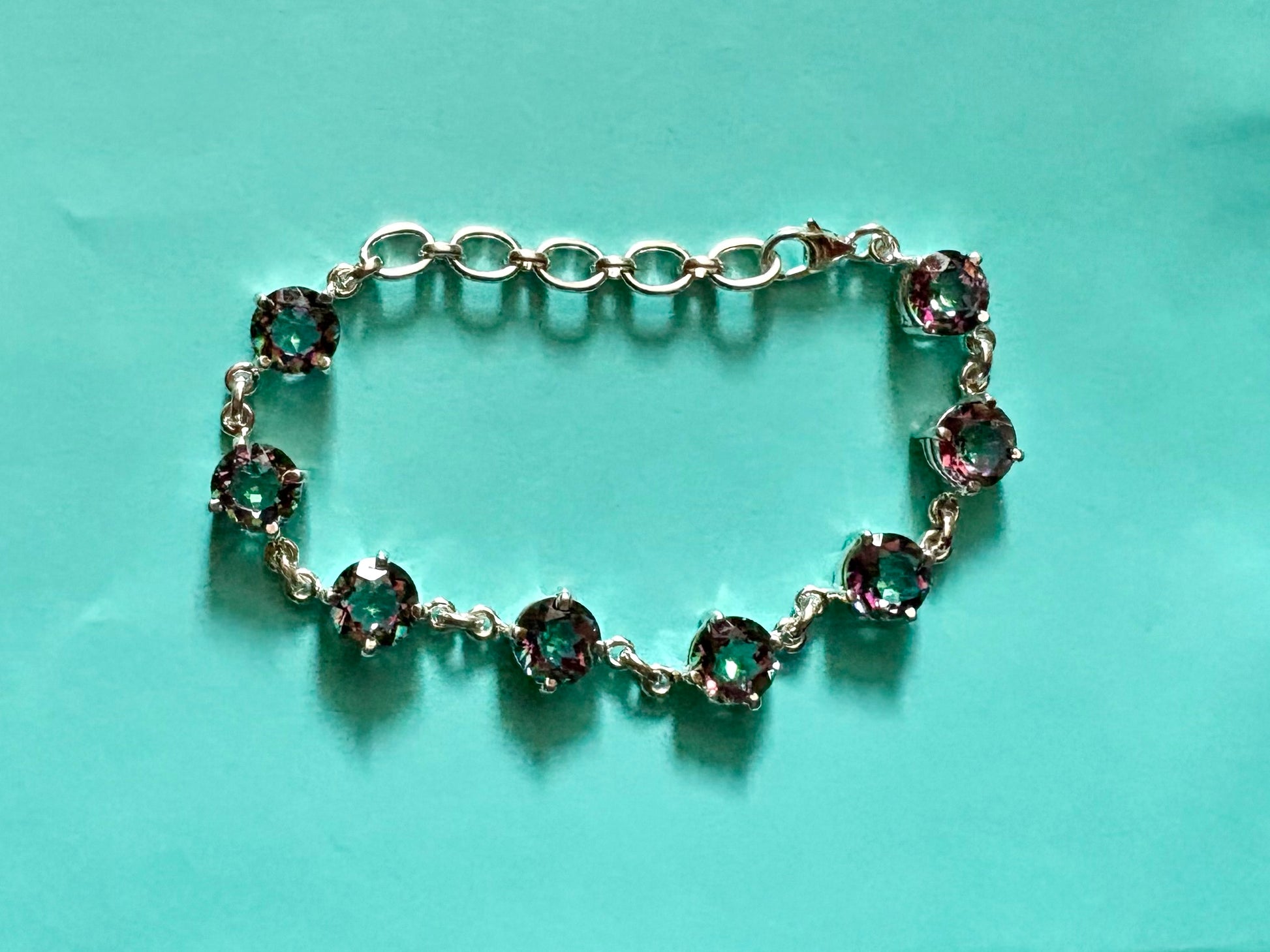 Sterling silver mystic quartz bracelet featuring iridescent round stones that shift colors in the light.