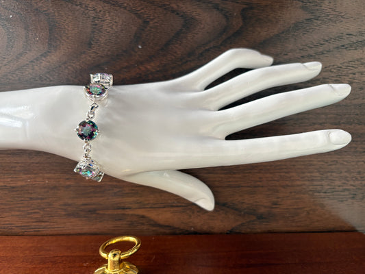 Sterling silver mystic quartz bracelet featuring iridescent round stones that shift colors in the light.