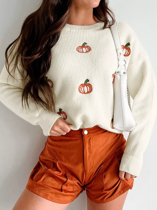 Cream knit sweater with embroidered pumpkins, round neck, and long sleeves – cozy fall style.