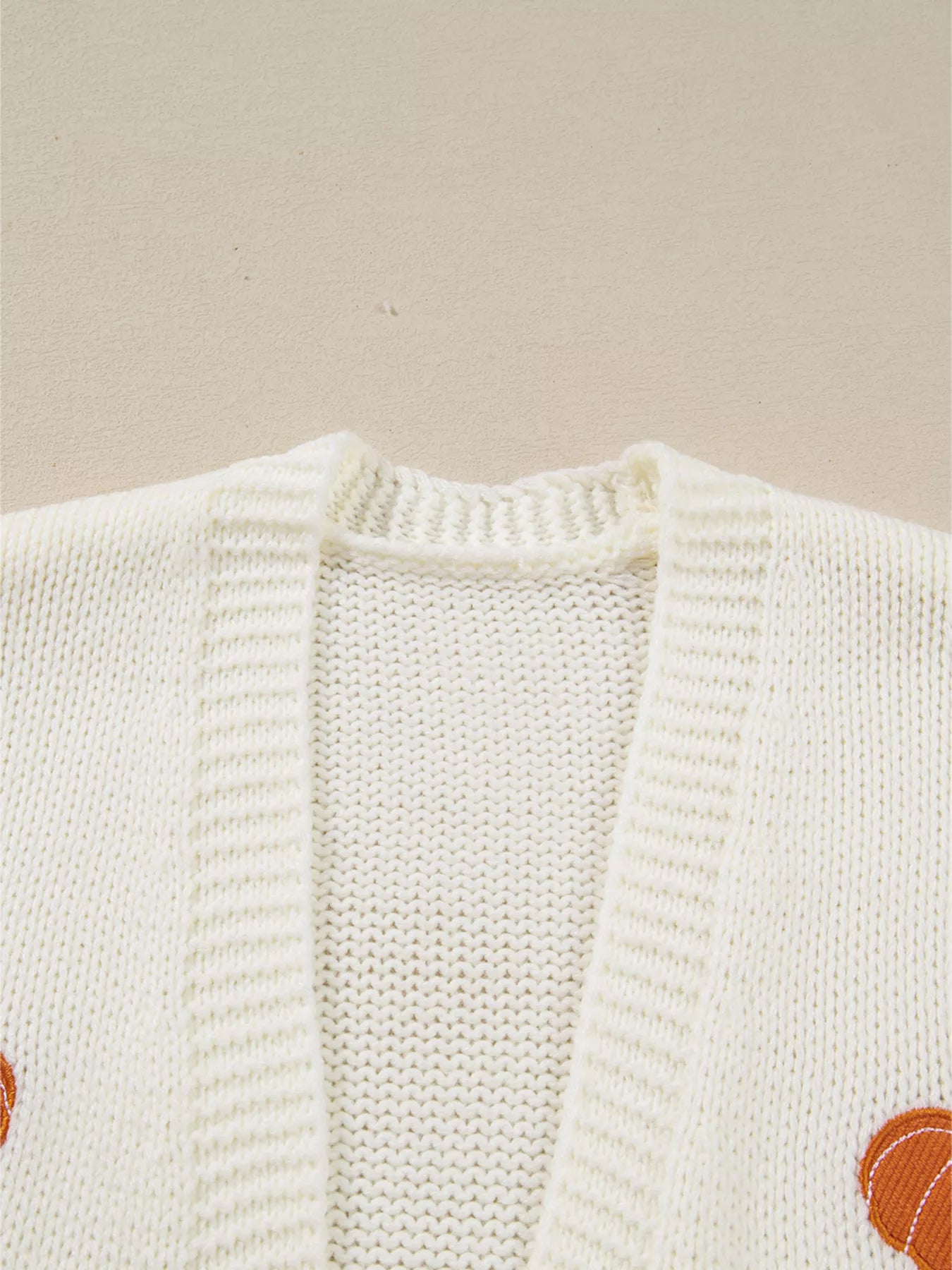 White knit cardigan with orange pumpkin embroidery – Pumpkin Patch style from A Whimsical Affair.