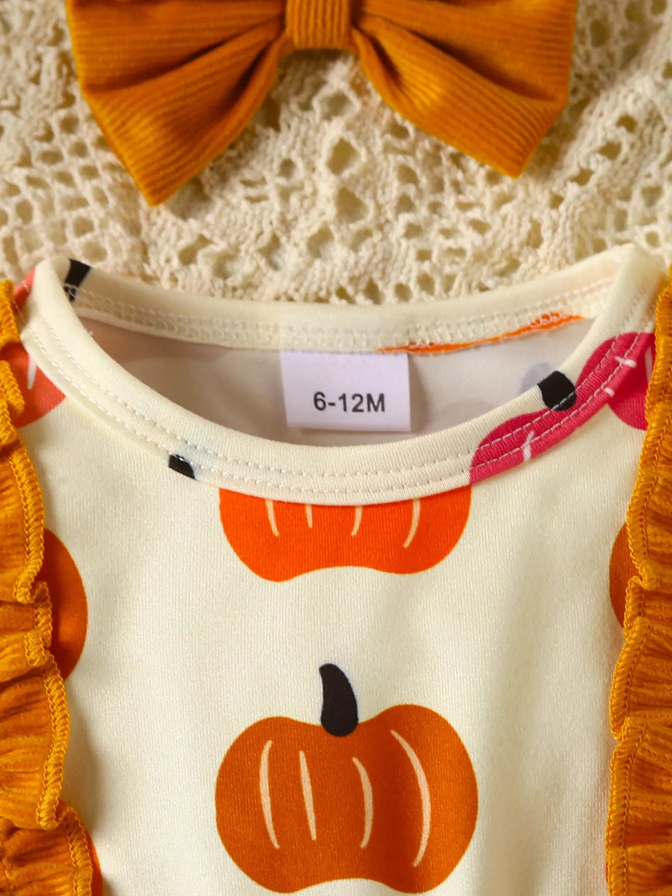 Baby girl pumpkin-print long-sleeve ruffle dress with bow headband and mustard corduroy skirt, styled for fall.