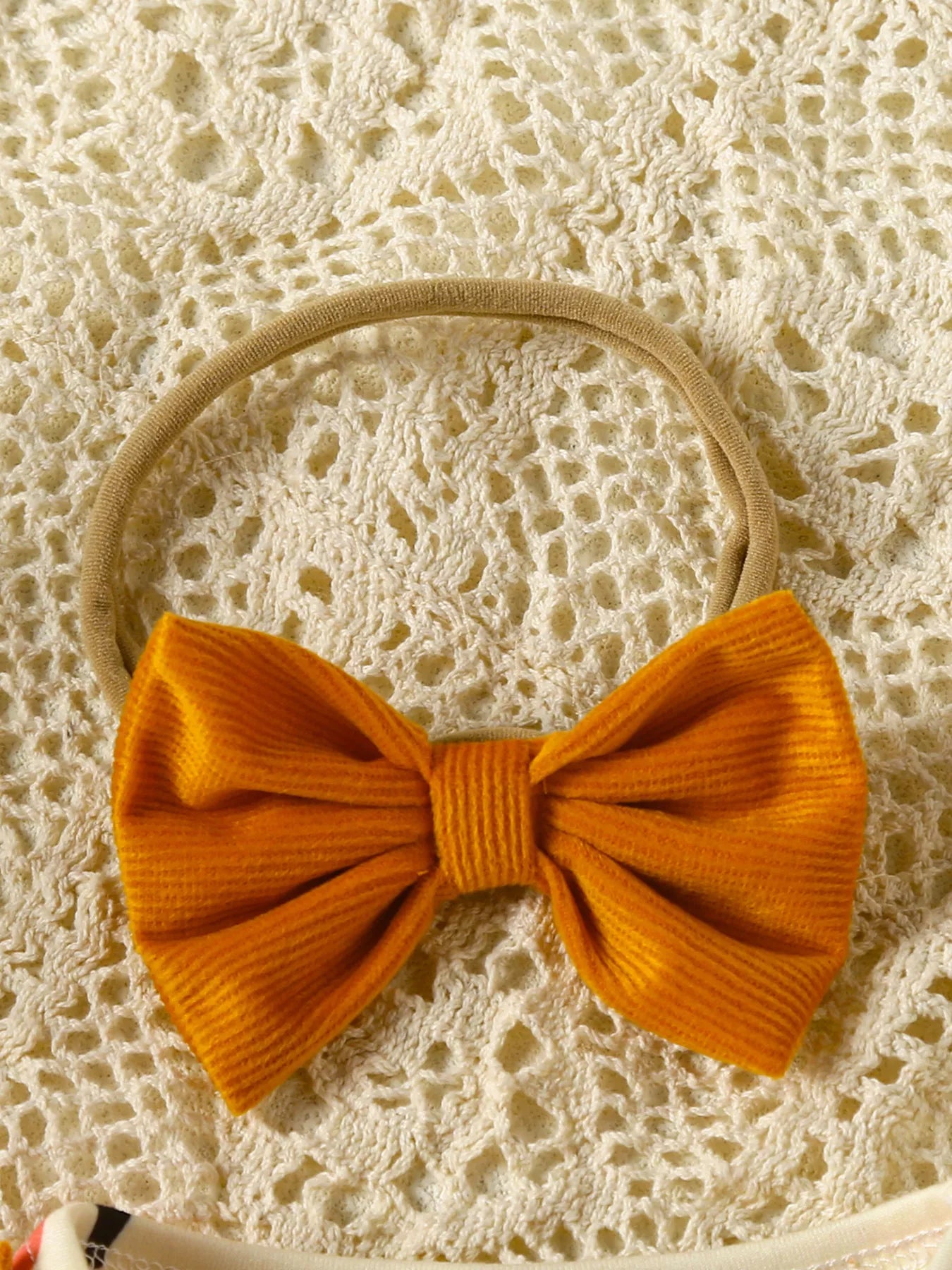 Baby girl pumpkin-print long-sleeve ruffle dress with bow headband and mustard corduroy skirt, styled for fall.