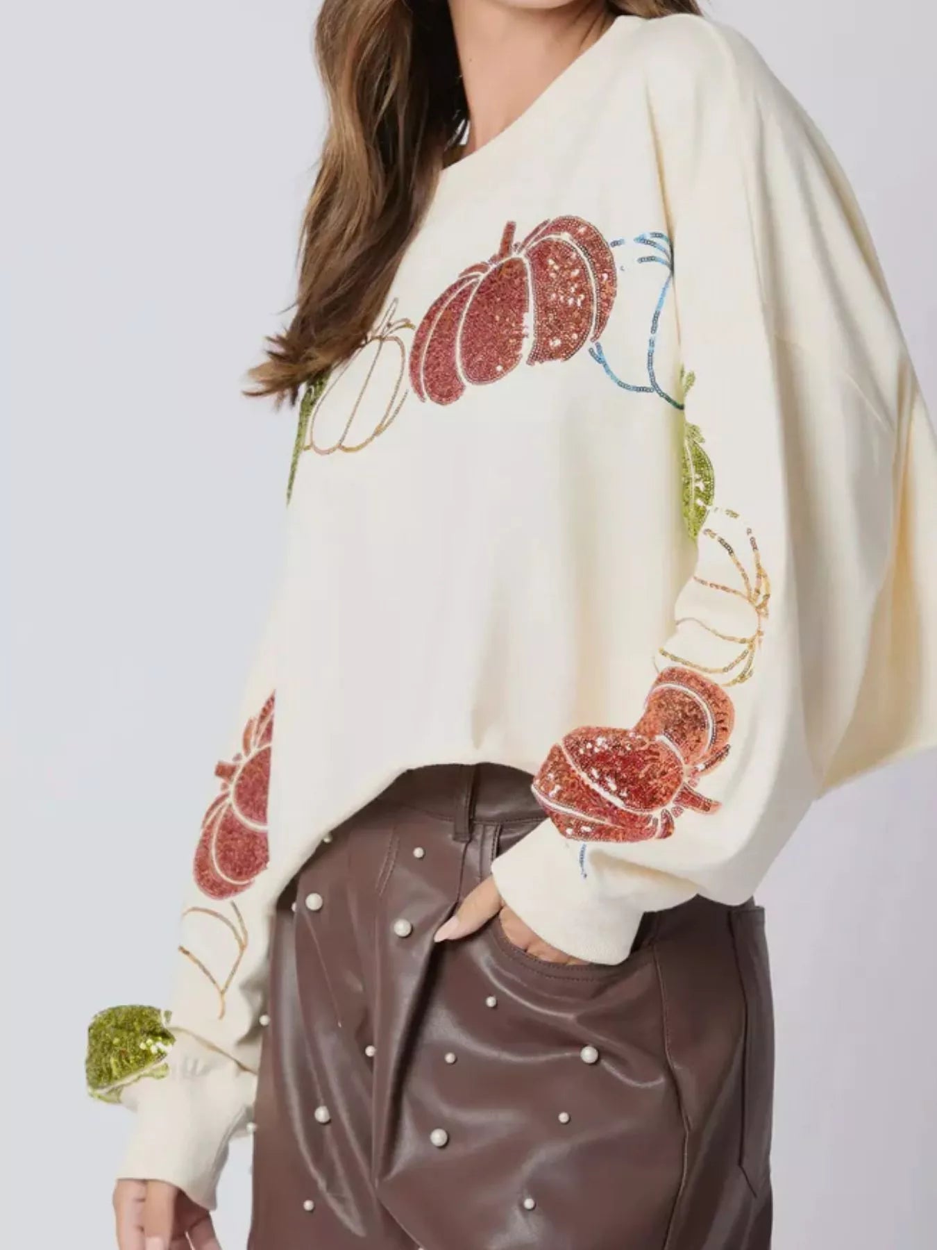 Pumpkin Patch Sparkle Sweatshirt in cream with sequin pumpkins on sleeves – festive autumn top