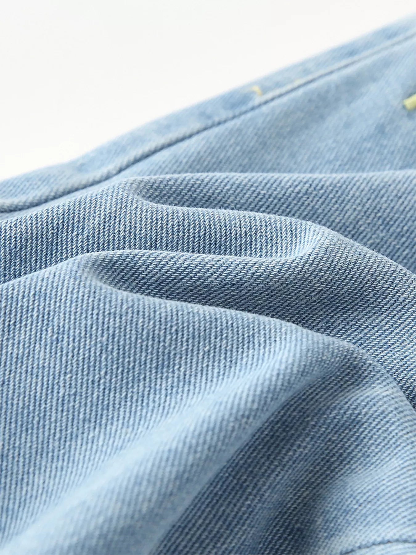 Light-wash kids' denim joggers with embroidered rainbow, bee, and butterfly details. Elastic waist and pockets for comfy, playful style.