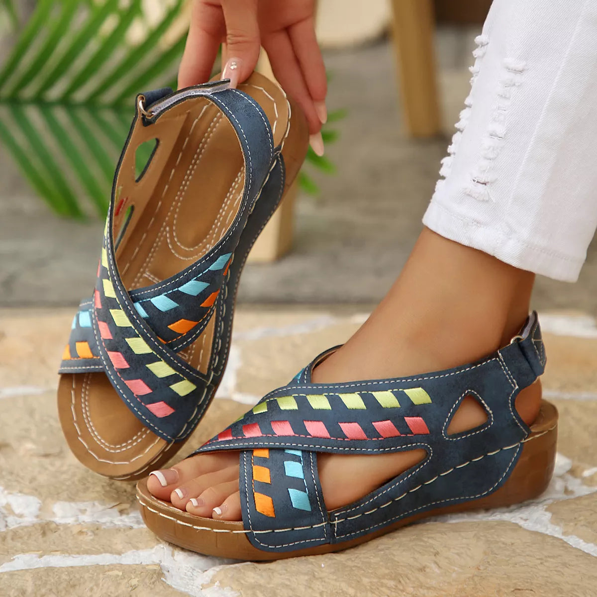 Blue boho mid heel sandals with colorful woven-style accents, cutout details, contrast stitching, and brown sole.