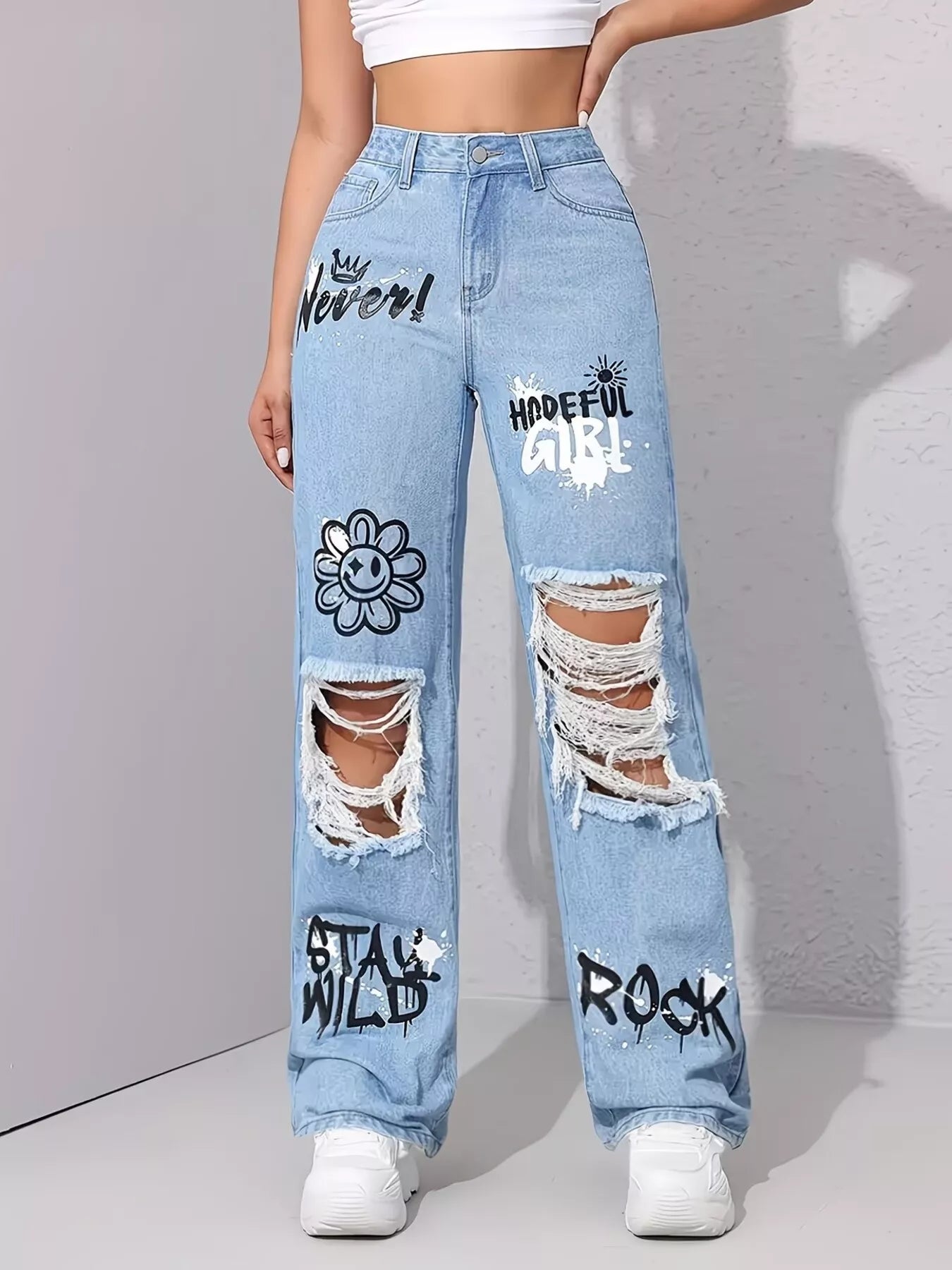 Light wash wide-leg jeans with distressed cutouts, raw hem details, seam accents, and black graphic print designs.