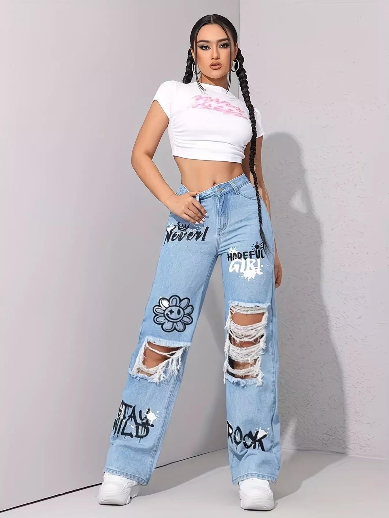 Light wash wide-leg jeans with distressed cutouts, raw hem details, seam accents, and black graphic print designs.