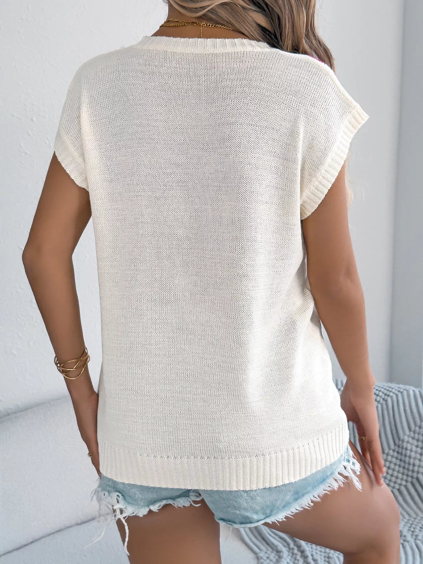 Women’s relaxed fit knit top with colorful floral accents and short sleeves