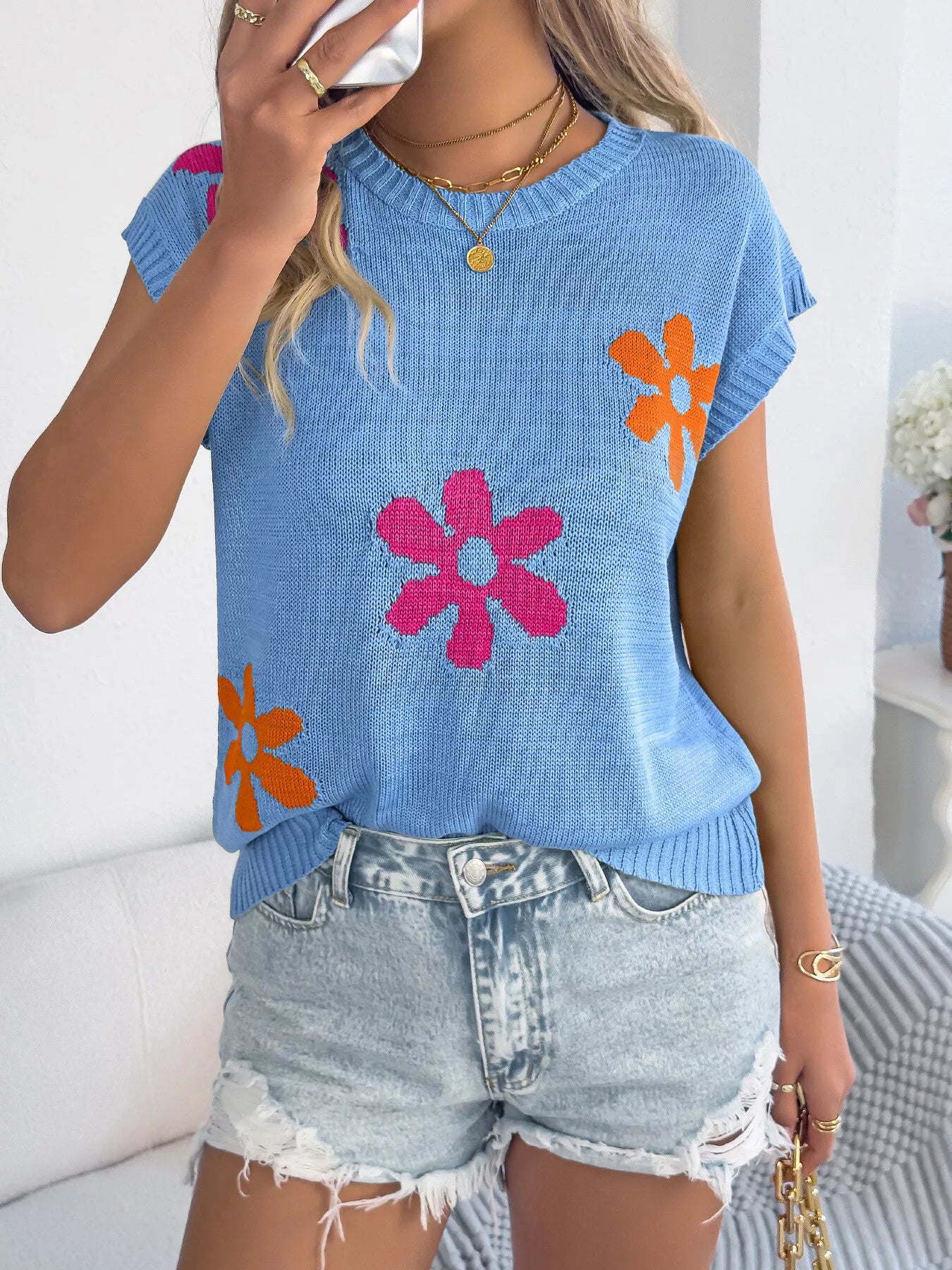 Women’s relaxed fit knit top with colorful floral accents and short sleeves