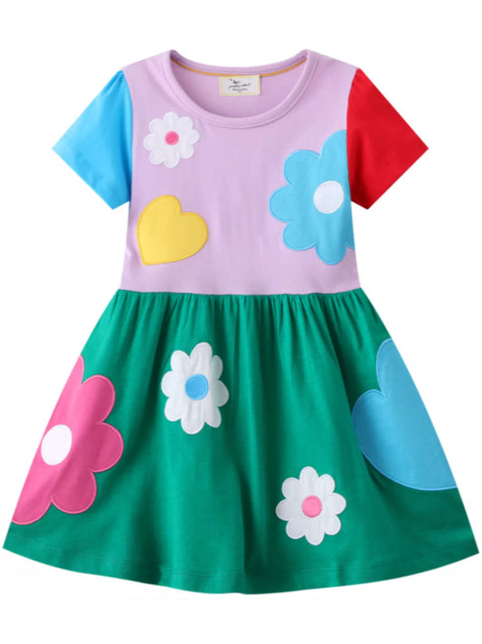 Colorful girls dress with oversized flower and heart appliqué and green skirt