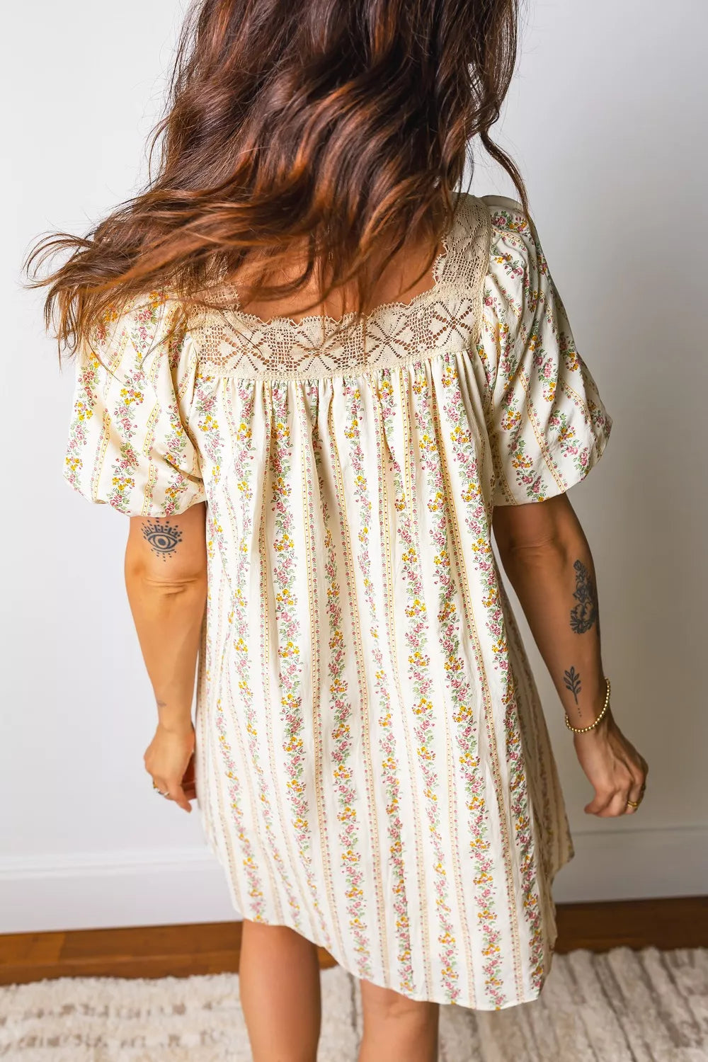 cream floral stripe babydoll dress with lace neckline, flutter sleeves, and pink satin bow detail