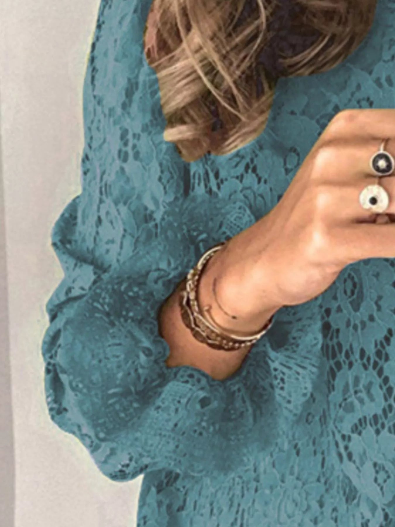 Blue floral lace long sleeve blouse with round neck and intricate lace design.