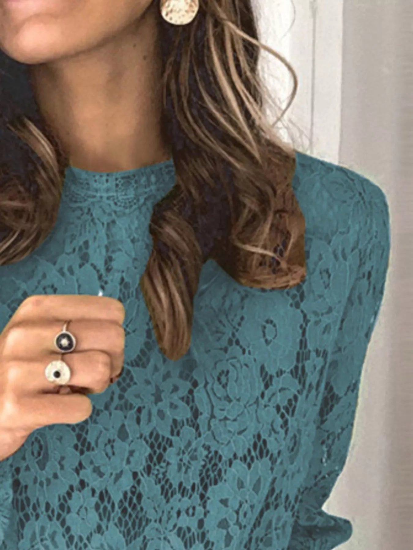 Blue floral lace long sleeve blouse with round neck and intricate lace design.