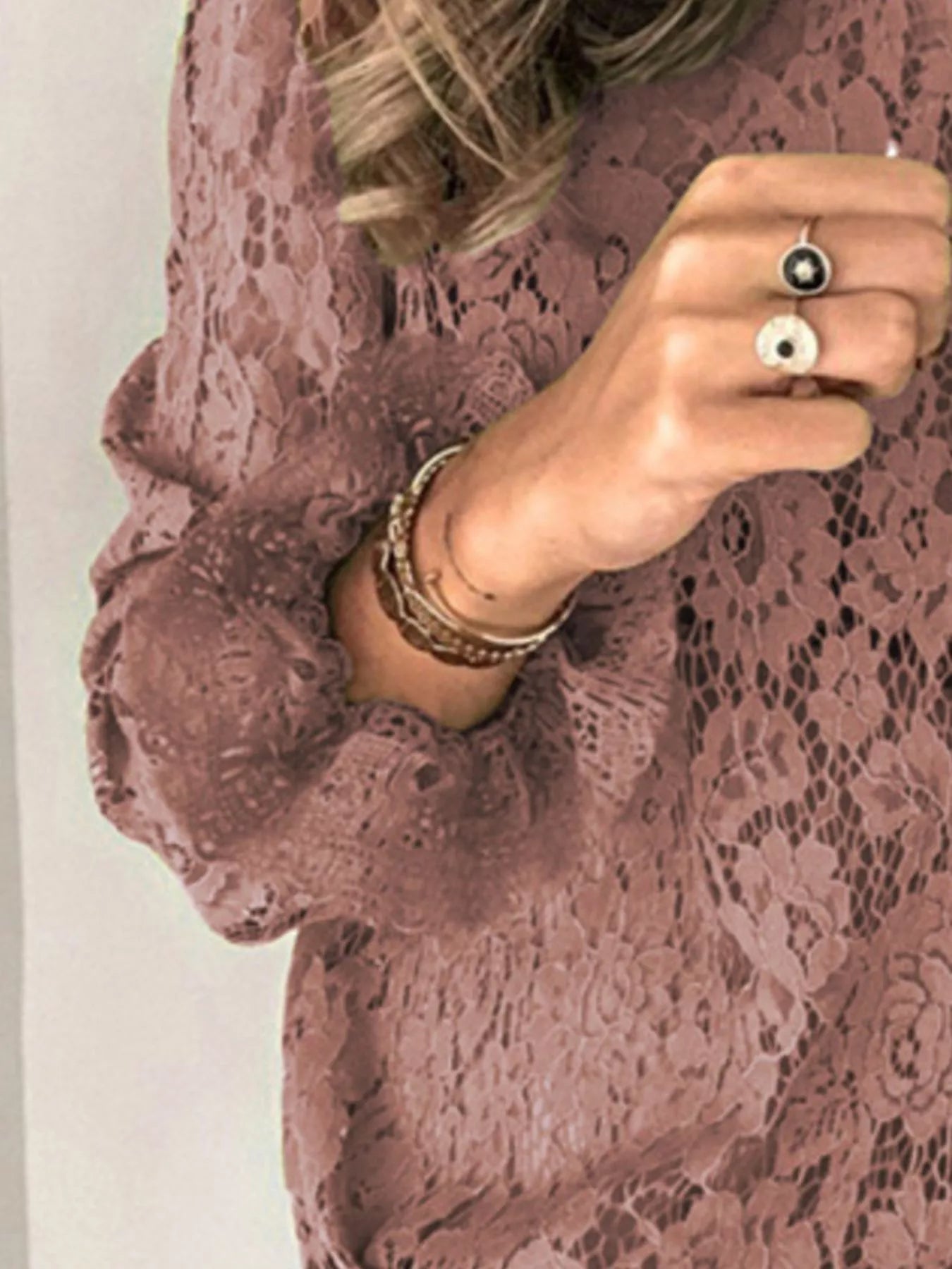 Pink floral lace long sleeve blouse with round neck and feminine lace pattern.