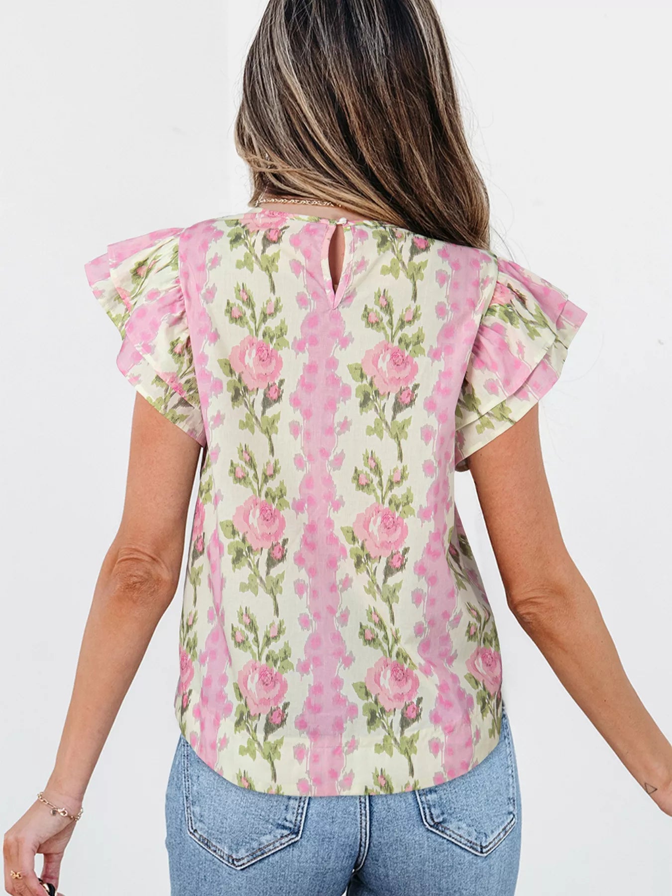 Pink floral cotton blouse with layered ruffle sleeves styled with light wash denim shorts and woven belt