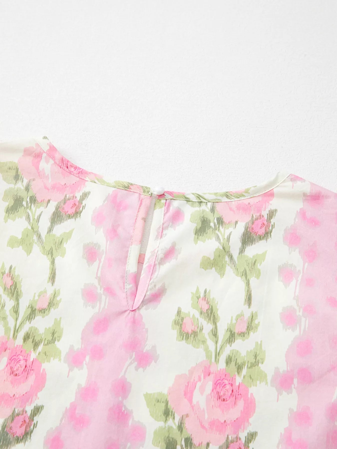 Pink floral cotton blouse with layered ruffle sleeves styled with light wash denim shorts and woven belt