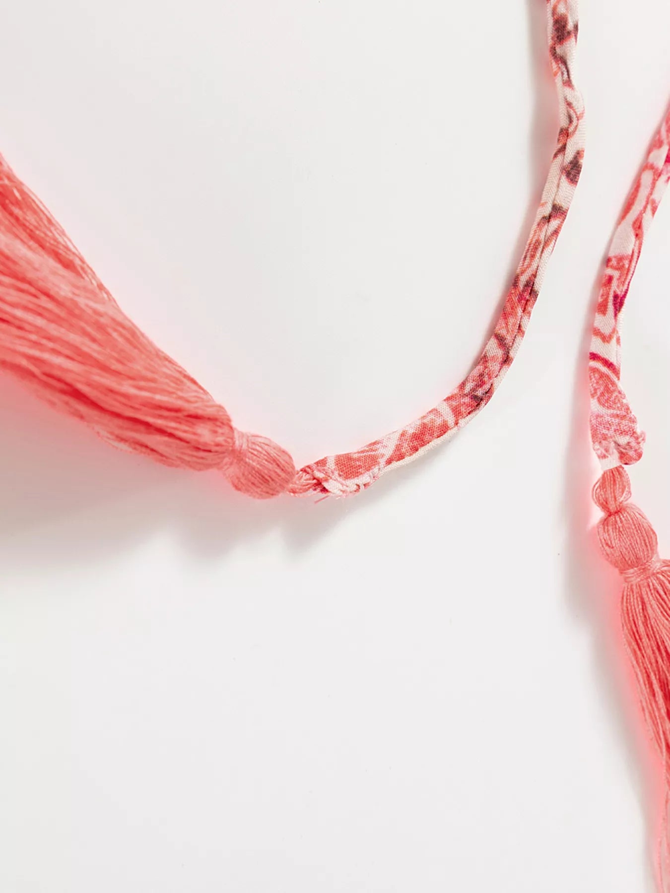 Rosé Reverie Mini Dress – flowy floral print boho dress with tassel tie neckline and ruffle details.
