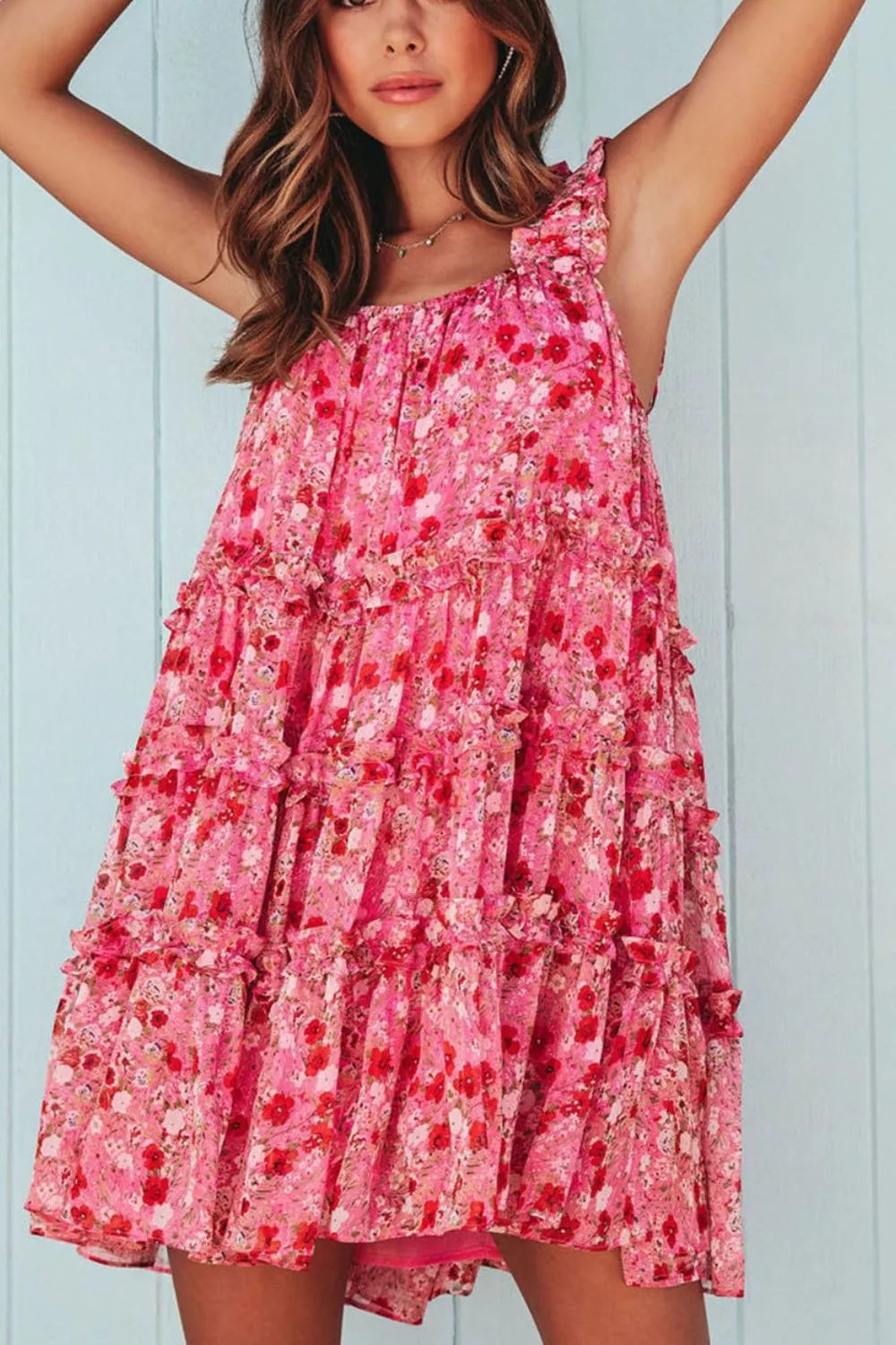 Pink tiered floral mini dress with ruffle detailing and sleeveless design