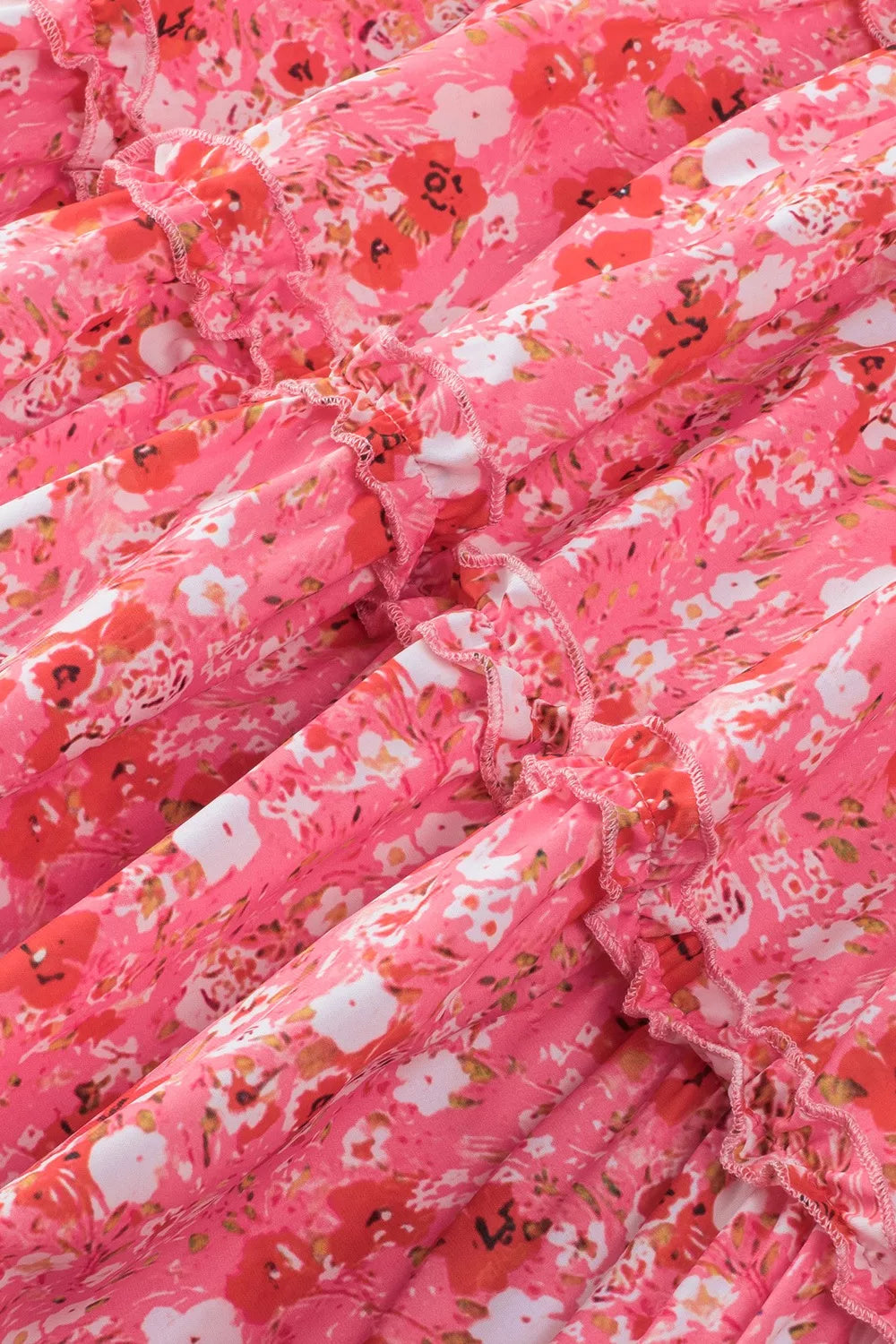 Pink tiered floral mini dress with ruffle detailing and sleeveless design