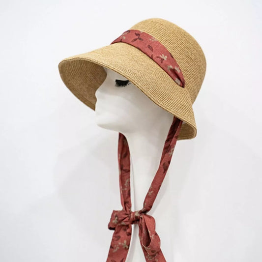 Woven straw sun hat with floral ribbon tie straps