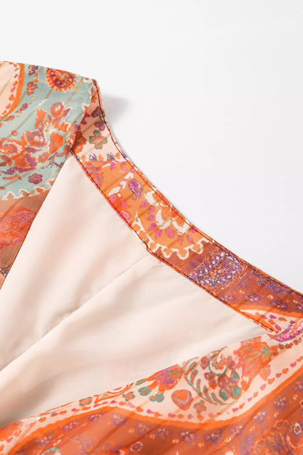 Boho paisley wrap mini dress in rust and sage tones with long sleeves and tie waist