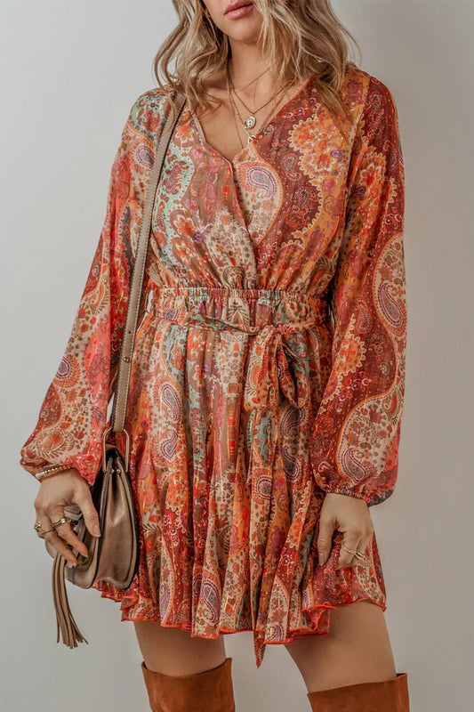 Boho paisley wrap mini dress in rust and sage tones with long sleeves and tie waist