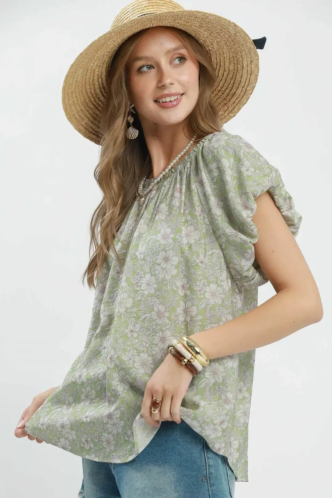 Floral puff sleeve blouse with a gathered round neckline, relaxed flowy fit, and lightweight rayon-blend fabric styled with denim shorts.