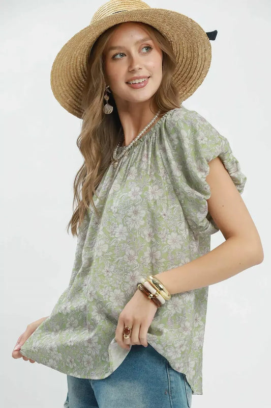 Floral puff sleeve blouse with a gathered round neckline, relaxed flowy fit, and lightweight rayon-blend fabric styled with denim shorts.