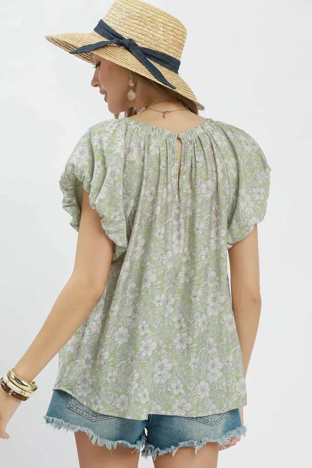 Floral puff sleeve blouse with a gathered round neckline, relaxed flowy fit, and lightweight rayon-blend fabric styled with denim shorts.