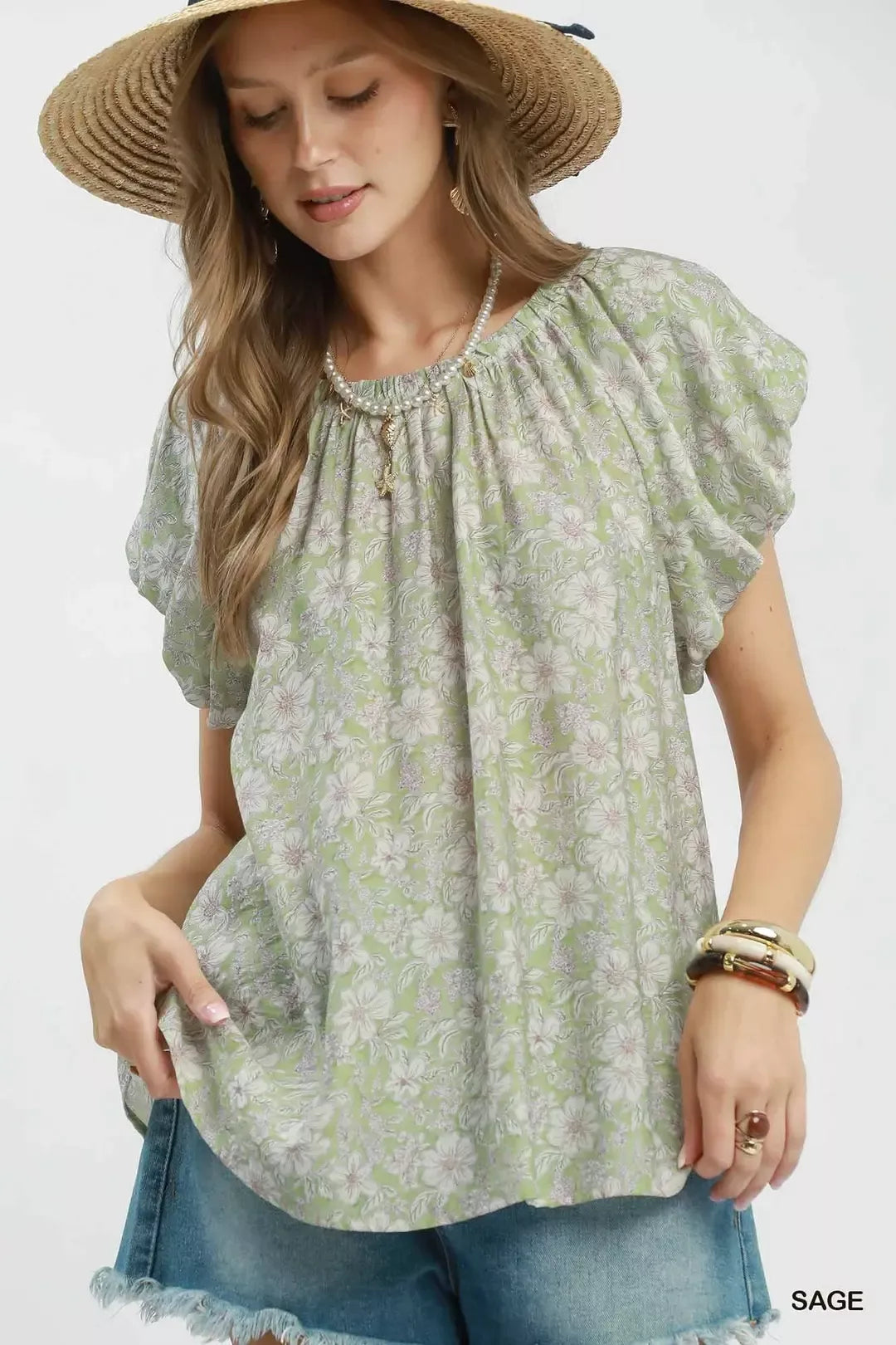 Floral puff sleeve blouse with a gathered round neckline, relaxed flowy fit, and lightweight rayon-blend fabric styled with denim shorts.