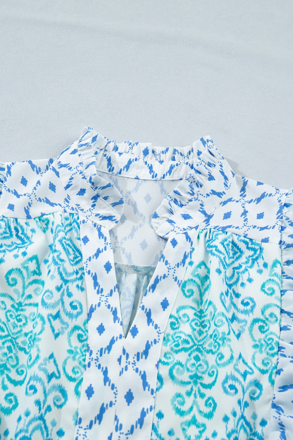 Blue printed mini dress with ruffle shoulders and puff sleeves
