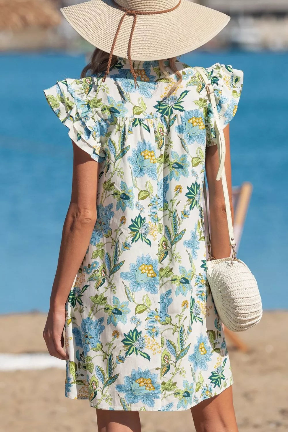 blue floral cottagecore mini dress with ruffle sleeves and relaxed breezy fit by the water