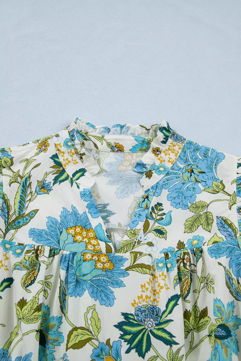 blue floral cottagecore mini dress with ruffle sleeves and relaxed breezy fit by the water