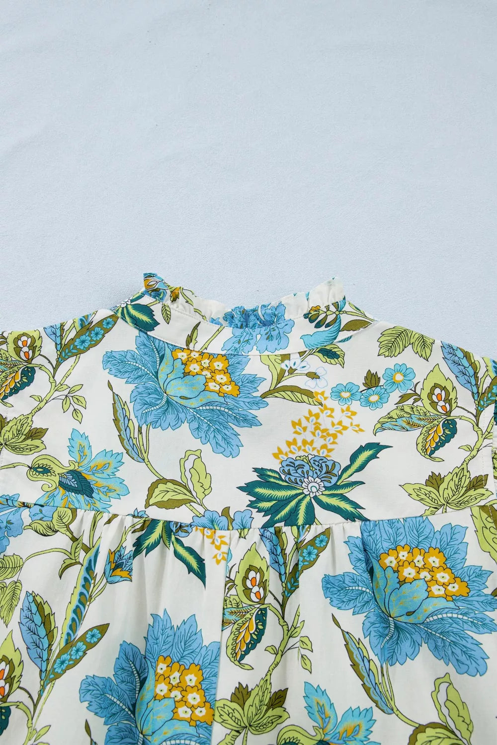 blue floral cottagecore mini dress with ruffle sleeves and relaxed breezy fit by the water