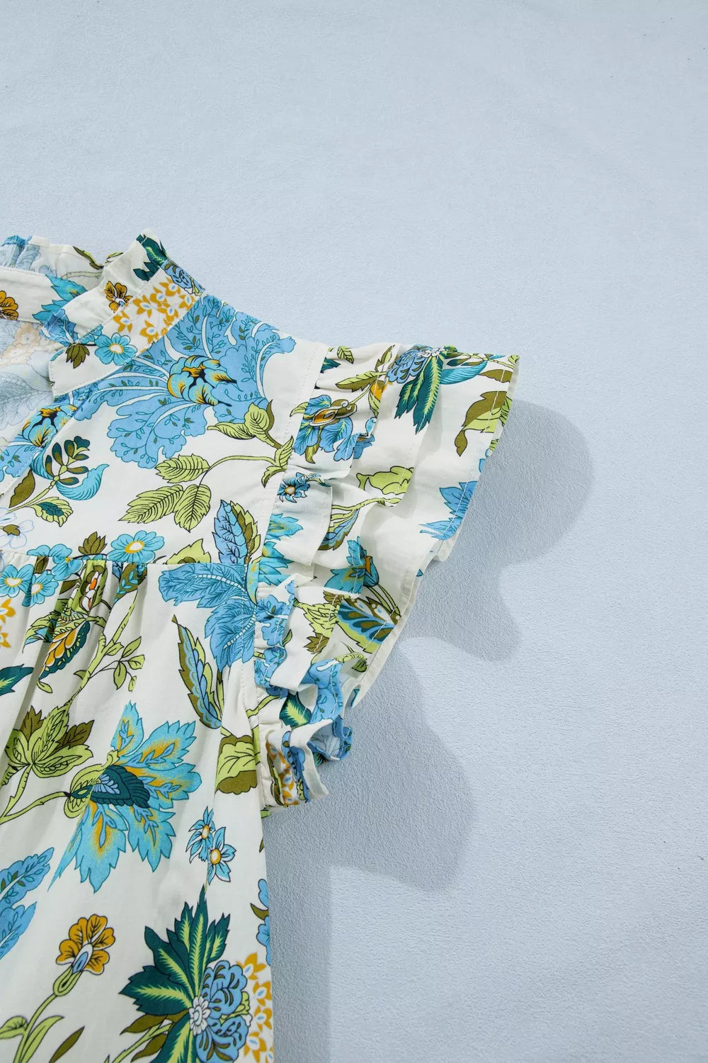 blue floral cottagecore mini dress with ruffle sleeves and relaxed breezy fit by the water