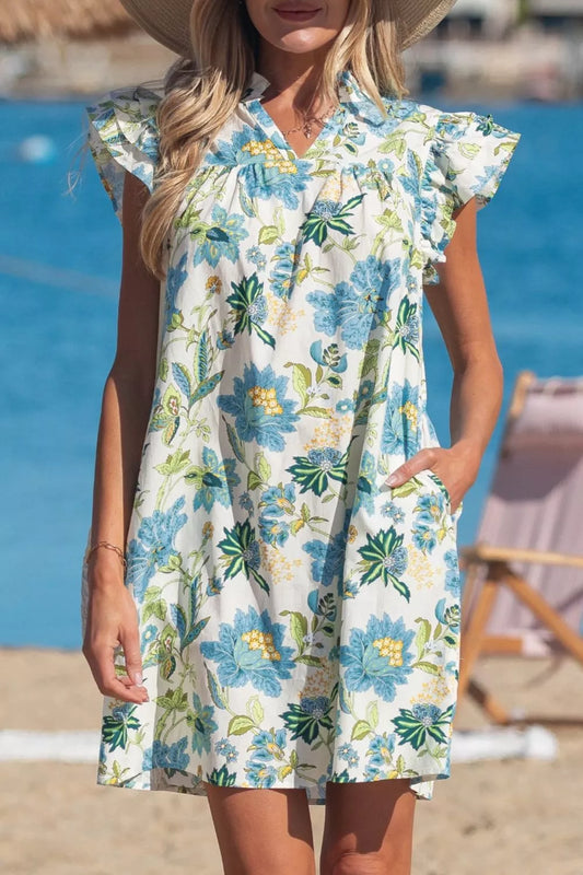 blue floral cottagecore mini dress with ruffle sleeves and relaxed breezy fit by the water