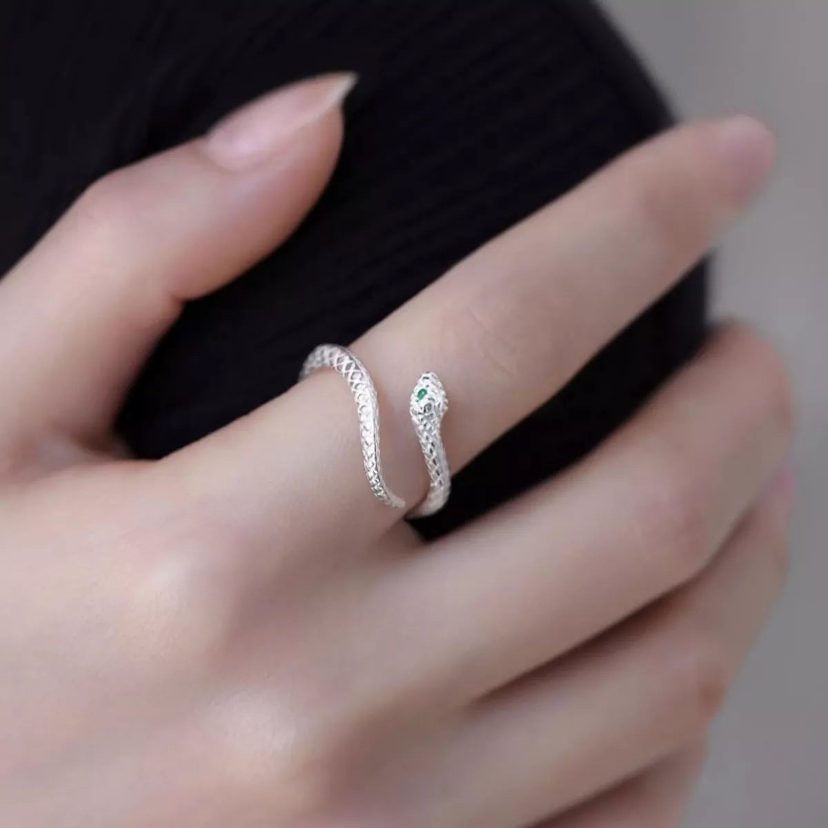 adjustable sterling silver snake wrap ring with textured serpent design worn on finger