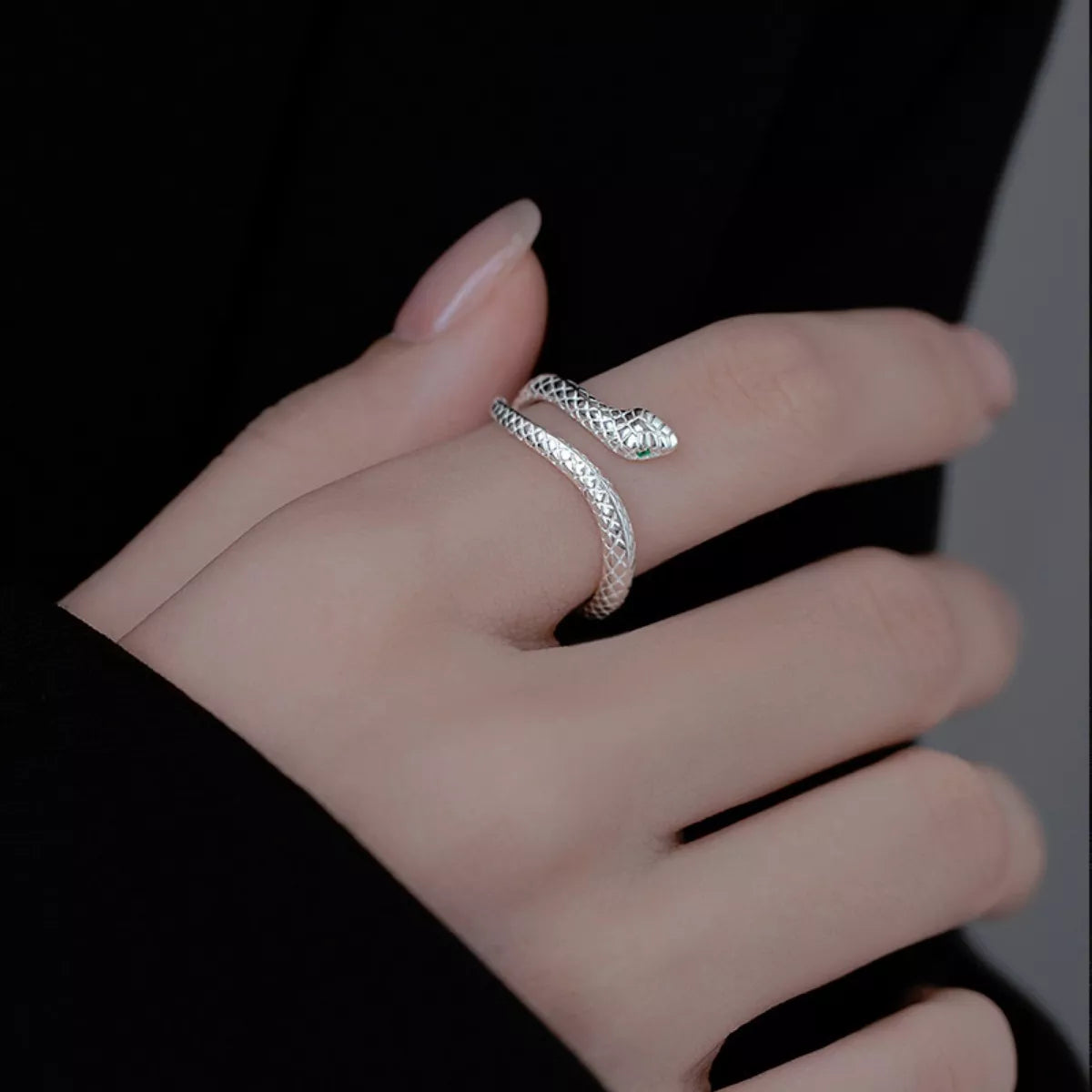 adjustable sterling silver snake wrap ring with textured serpent design worn on finger