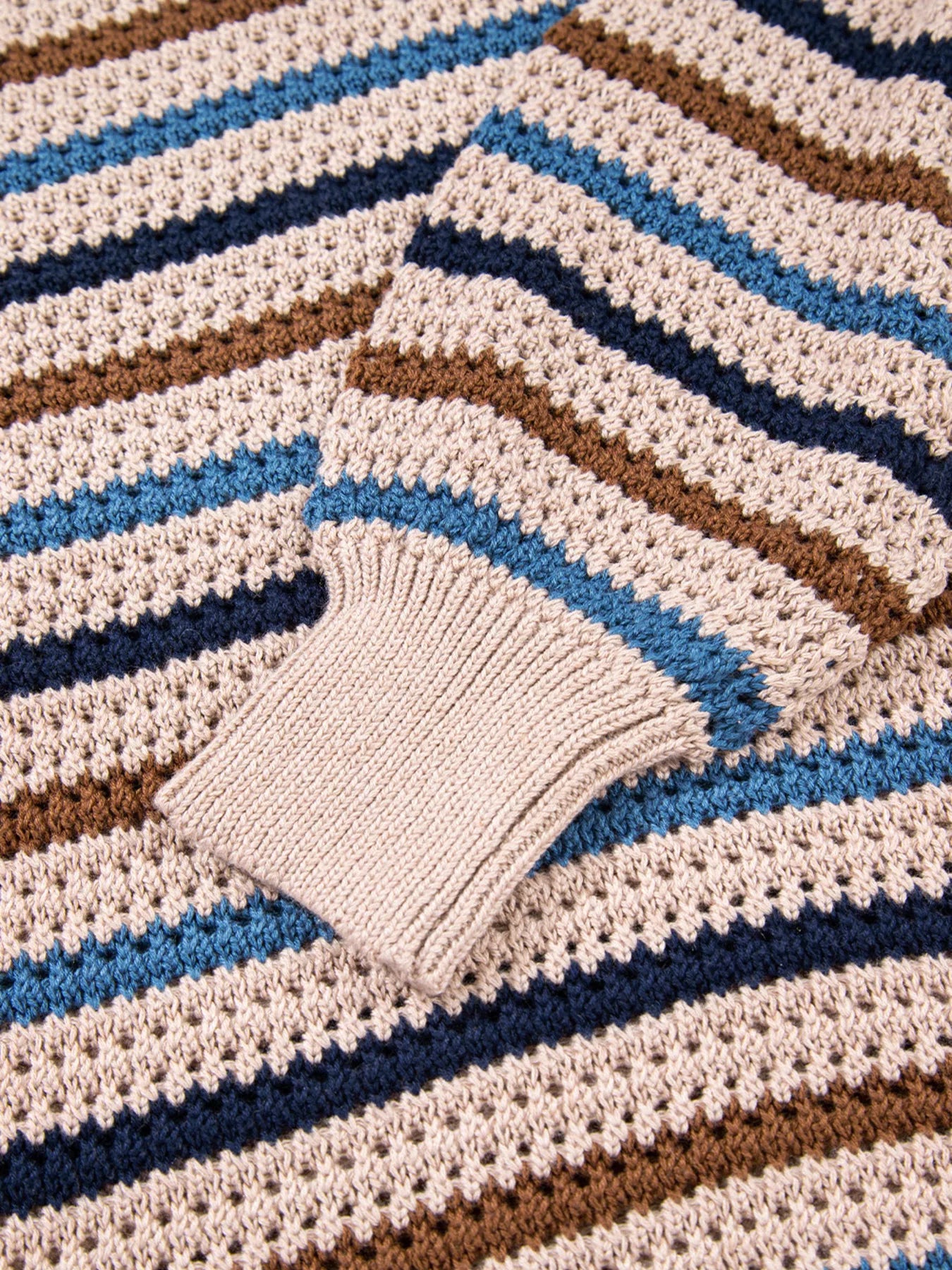 Brown and blue striped knit sweater with relaxed fit and cozy long sleeves