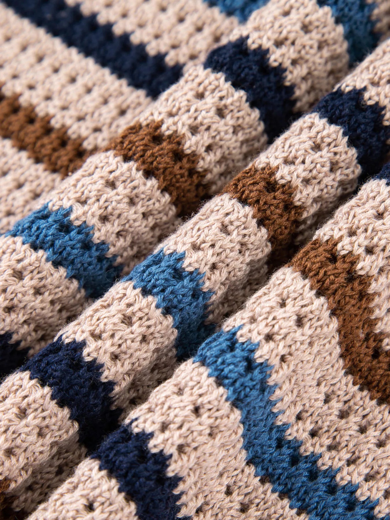 Brown and blue striped knit sweater with relaxed fit and cozy long sleeves