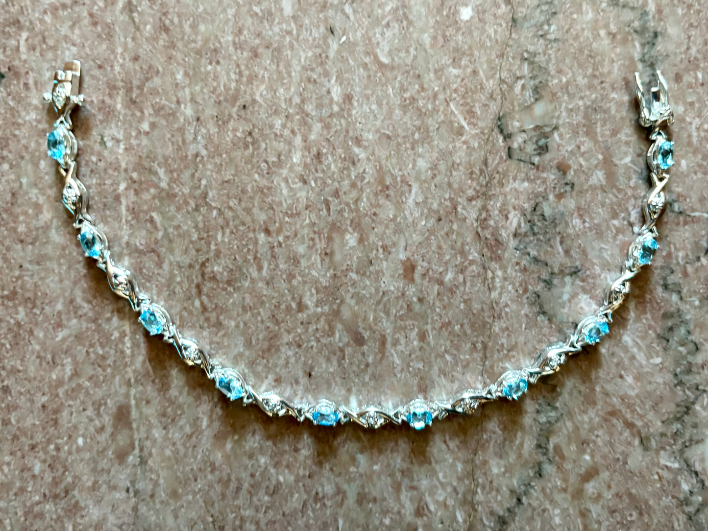 Sterling silver blue topaz bracelet from the Enchanted Crystals Collection featuring delicate light blue stones.
