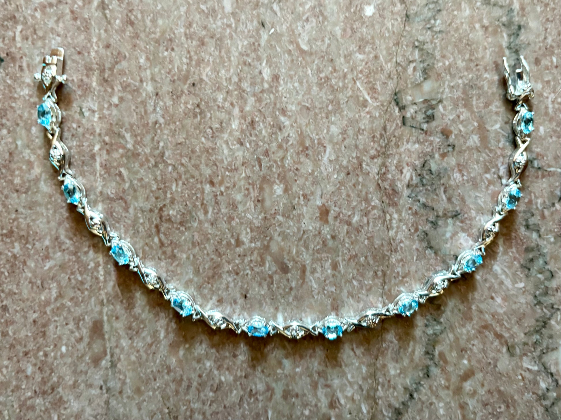 Sterling silver blue topaz bracelet from the Enchanted Crystals Collection featuring delicate light blue stones.