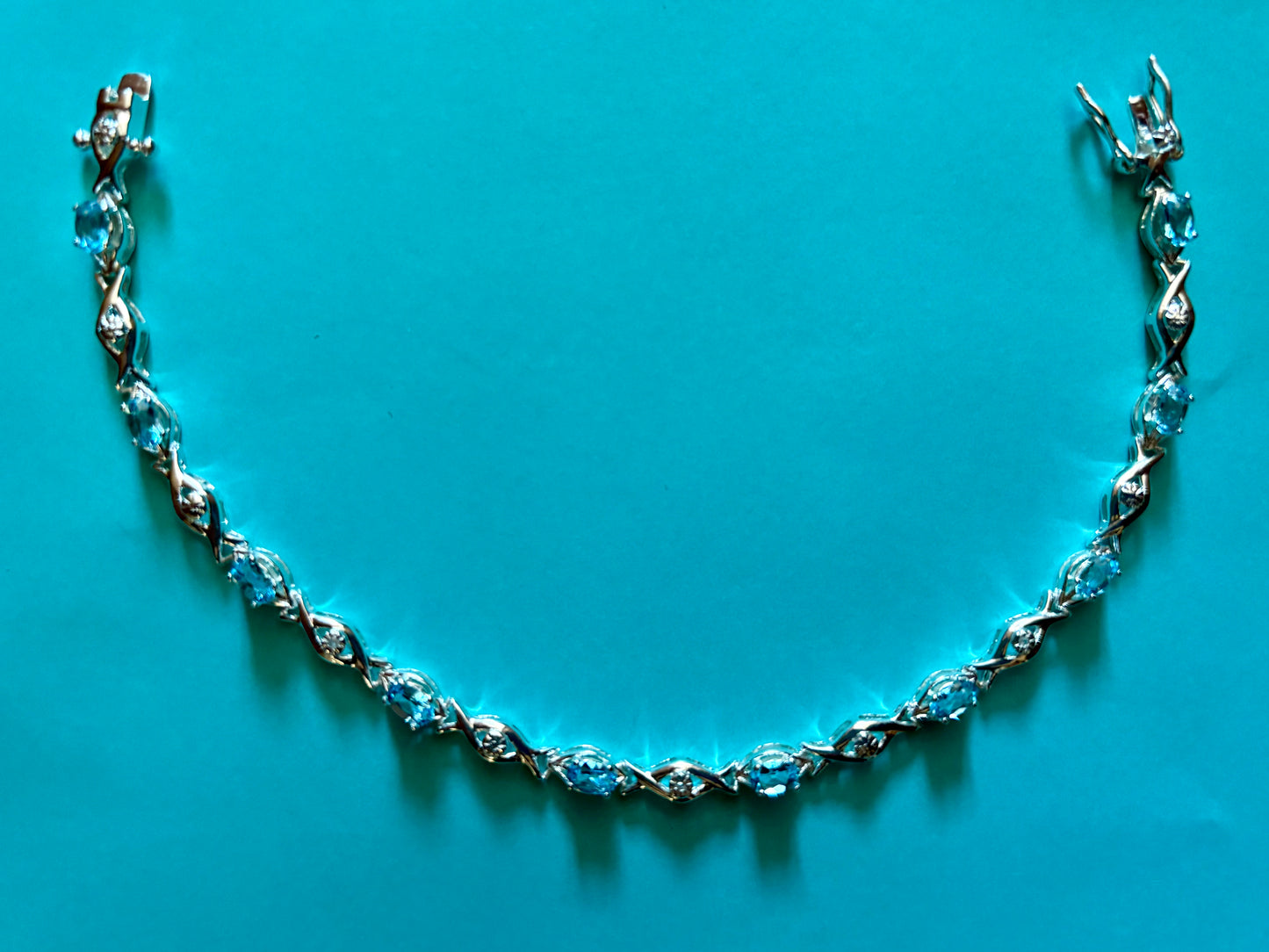 Sterling silver blue topaz bracelet from the Enchanted Crystals Collection featuring delicate light blue stones.